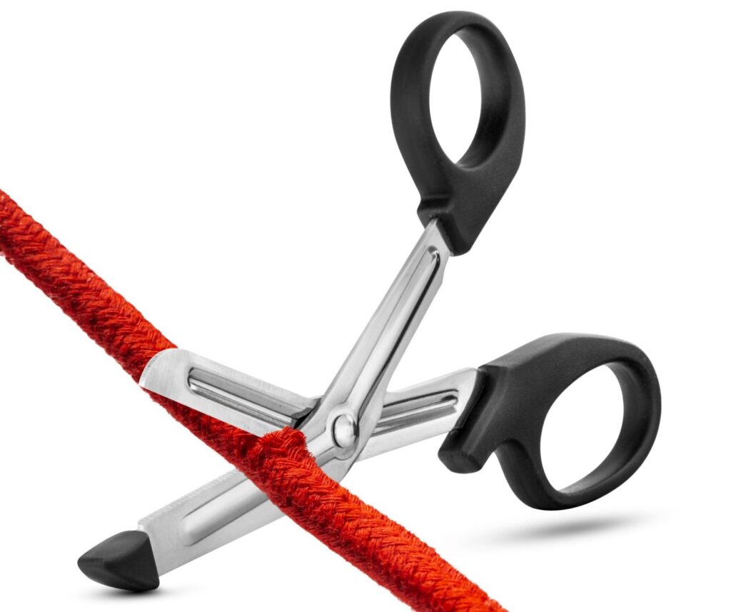 Image shows the Blush Safety Shears easily cutting through a red cotton rope | Kinkly Shop