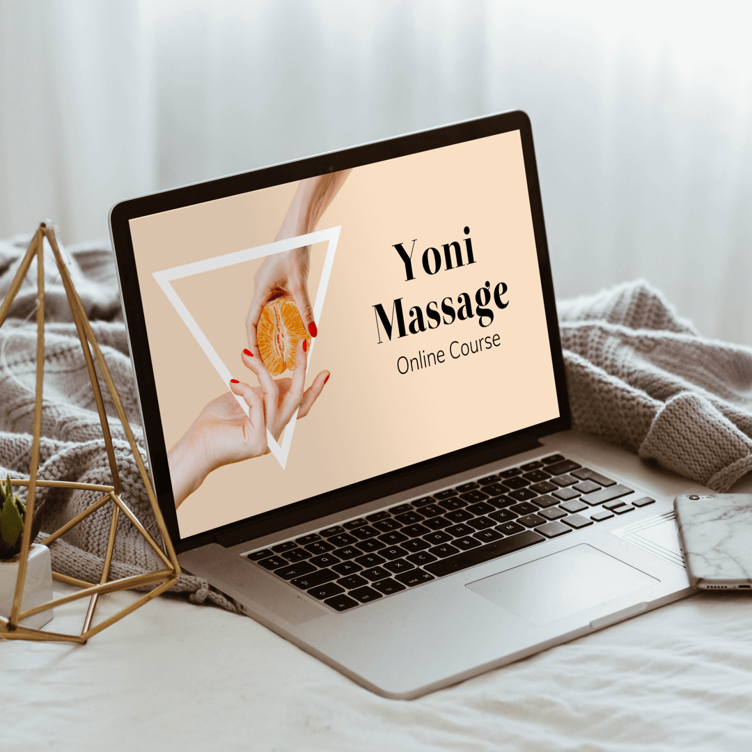 Yoni Massage Online Course on laptop on bed with sweater