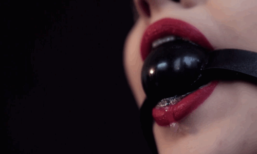 woman with red lipstick wearing ball gag and drooling